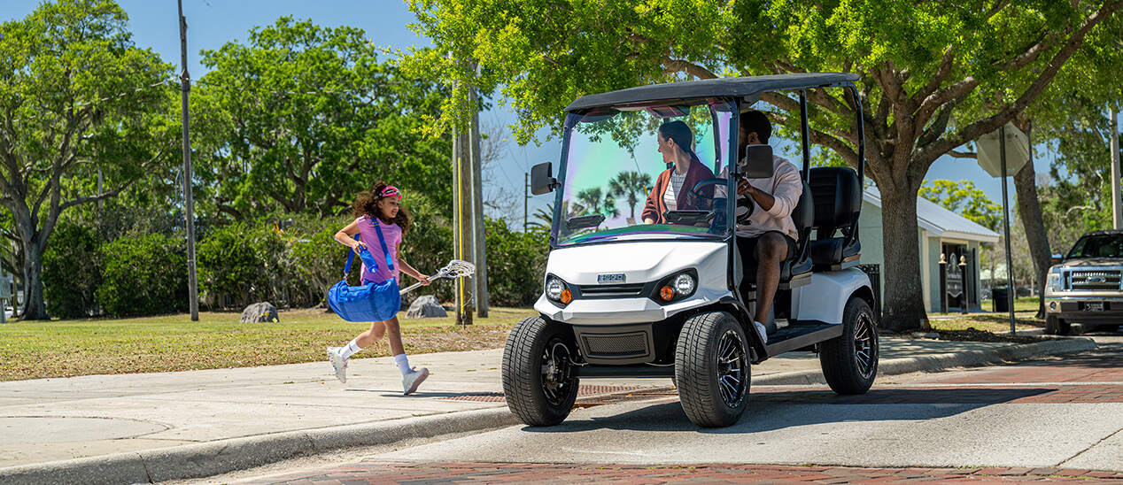 EZGO Golf Cart on Street with Family