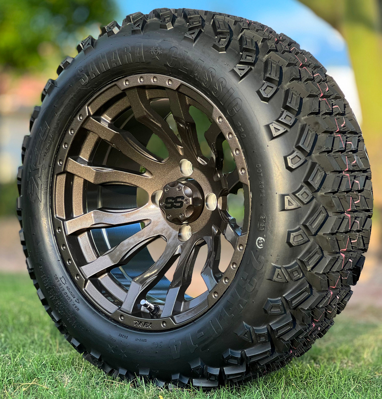 14 inch MAVERICK Metallic Bronze Golf Cart Wheels and 23x10-14 All Terrain Golf Cart Tires Combo in Grass