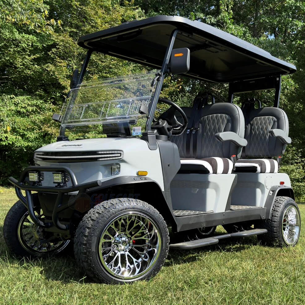 15 inch CONVICT Chrome Golf Cart Wheels and 23x10R15 All Terrain Tires on a Lifted Cart in the Grass