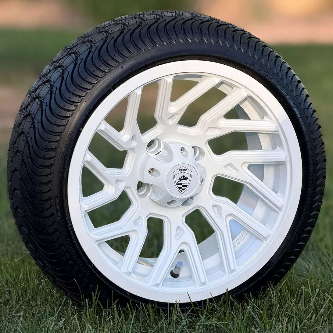 TREX 14 inch OPTIMUS Gloss White Golf Cart Wheels and 205/30-14 golf cart tires standing in grass 