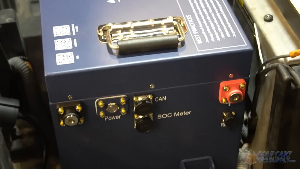 ALLIED battery ports facing the driver side Power button, CAN and SOC meter ports on the ALLIED battery facing the driver side of a golf cart