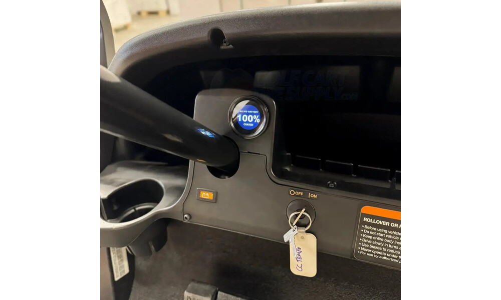 State-of-charge meter mounted in a Club Car dash Round lithium state-of-charge meter reading 100 percent mounted in the dash of a Club Car golf cart next to the key switch