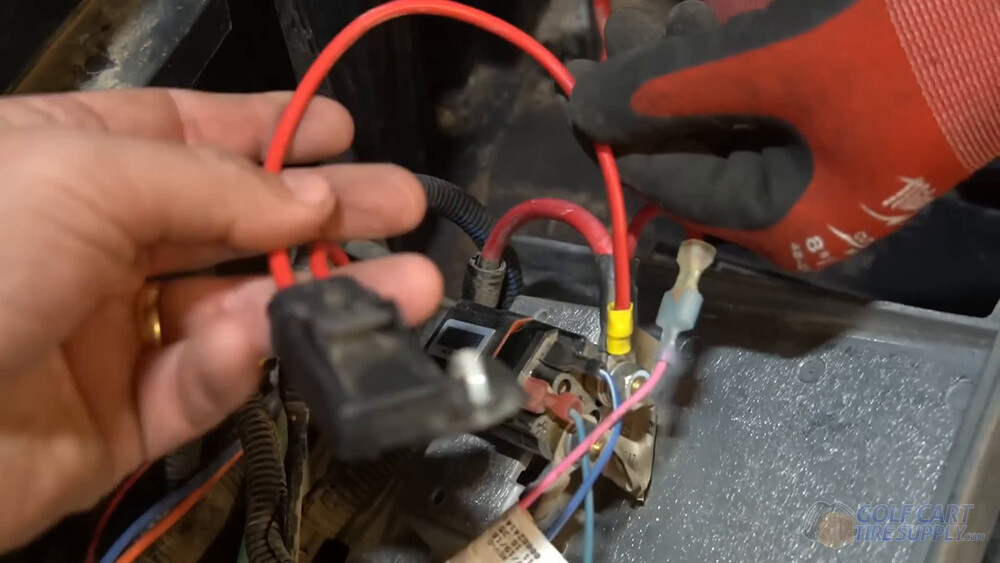Red charge port wire and fuse on a Club Car Tempo Red charge receptacle wire with its inline fuse at the solenoid in a 2019 Club Car Tempo golf cart