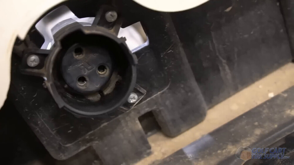 Club Car Tempo factory three-pin charge receptacle Factory round three-pin charge receptacle and its mounting screws on a 2019 Club Car Tempo golf cart