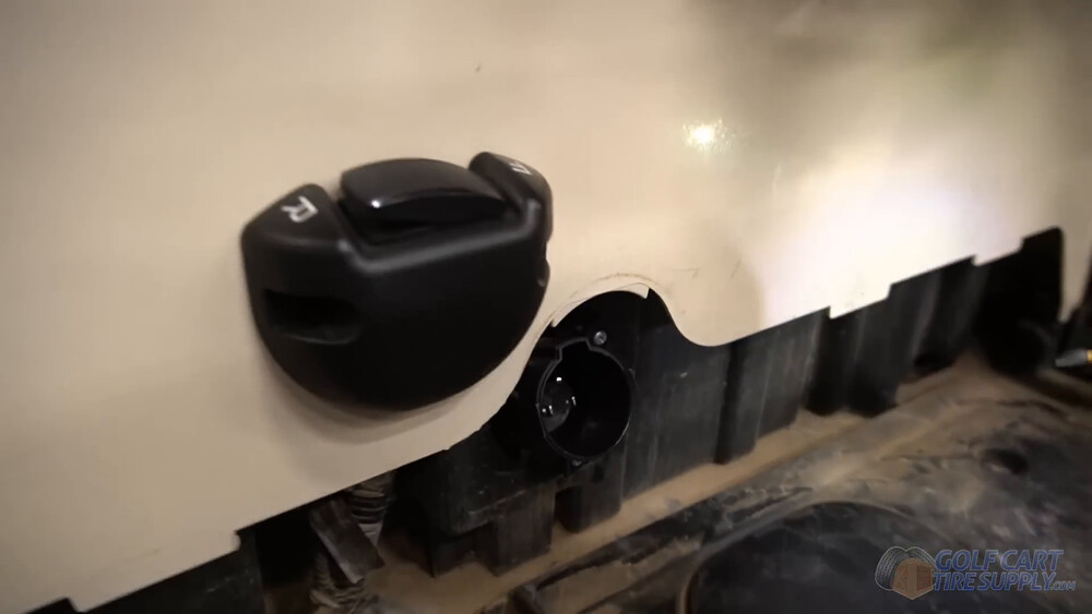 New charge receptacle on a Club Car Tempo New 110V charge receptacle installed beside the forward and reverse switch on a white 2019 Club Car Tempo golf cart