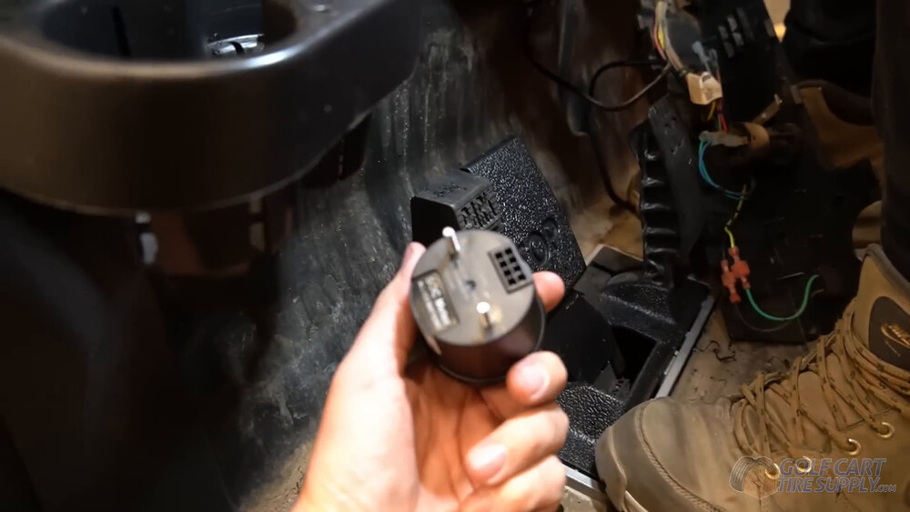 Back of the SOC gauge for a Club Car Tempo Back of the SOC meter gauge with its connector and mounting studs held under the dash of a 2019 Club Car Tempo golf cart