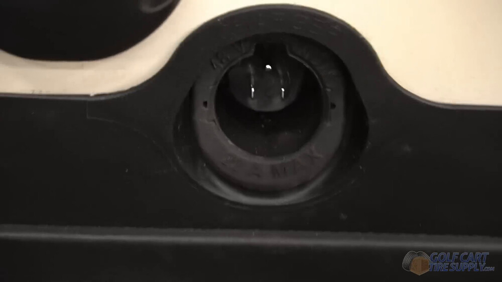Charge port trim ring back on a Club Car Tempo Charge receptacle trim ring snapped back into the kick panel of a white 2019 Club Car Tempo golf cart