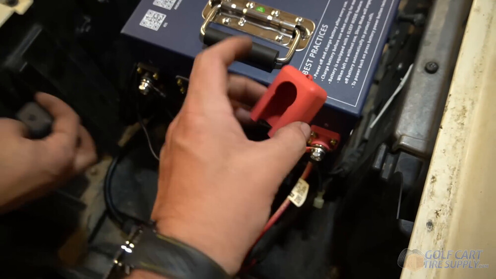 Terminal covers on the ALLIED battery in a Club Car Tempo Red terminal cover going onto the positive terminal of the ALLIED lithium battery in a 2019 Club Car Tempo golf cart