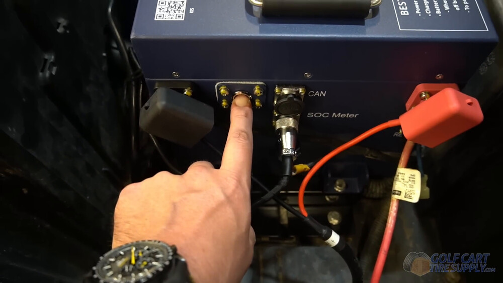 Powering on the ALLIED battery in a Club Car Tempo Finger pressing the power button on the ALLIED 48V lithium battery in a 2019 Club Car Tempo golf cart