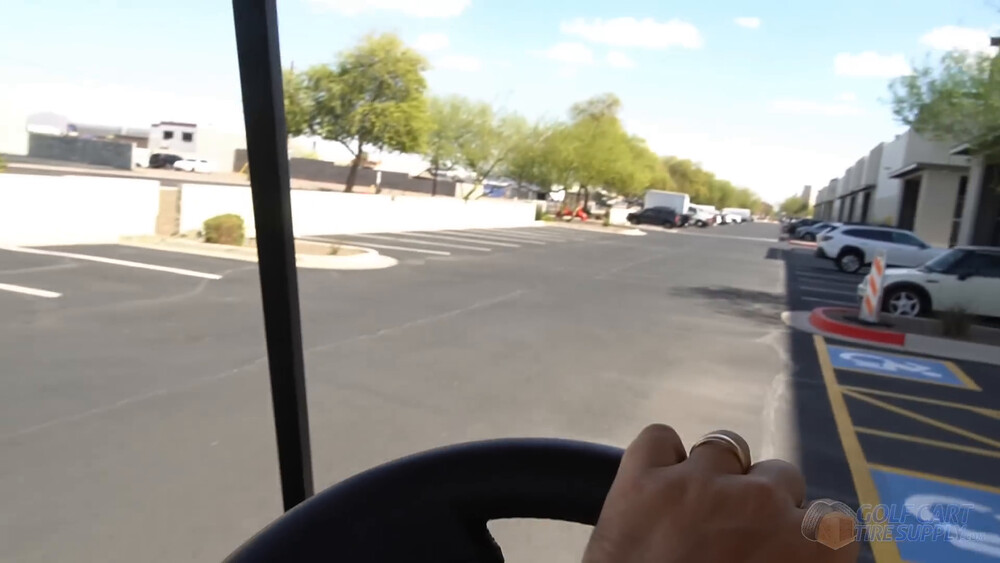 Driving a Club Car Tempo after the lithium conversion Driver view from a 2019 Club Car Tempo golf cart rolling through a sunny parking lot after the lithium conversion