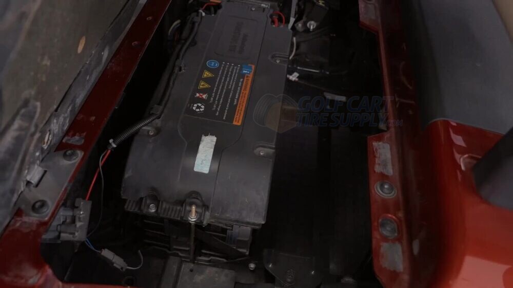 Gen 1 EZGO RXV ELiTE black Samsung factory lithium battery Black Samsung SDI factory lithium battery sitting in a Gen 1 EZGO RXV ELiTE golf cart