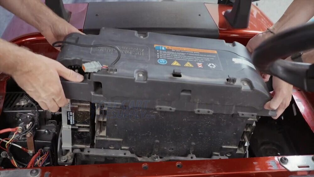 Removing the black Samsung factory lithium pack from an EZGO RXV Lifting the black Samsung factory lithium battery out of a Gen 1 EZGO RXV