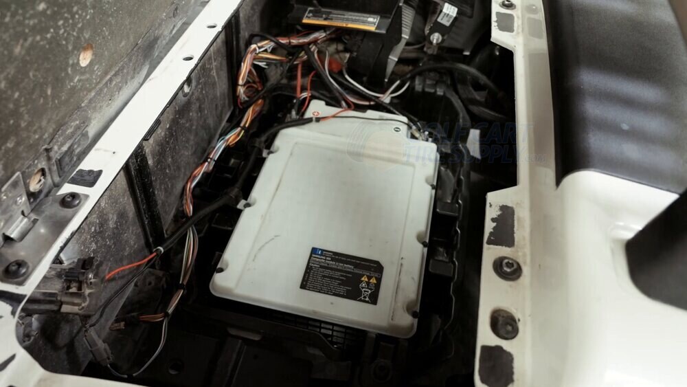 Gen 2 EZGO RXV ELiTE white Samsung factory lithium battery White Samsung SDI factory lithium battery sitting in a Gen 2 EZGO RXV ELiTE golf cart