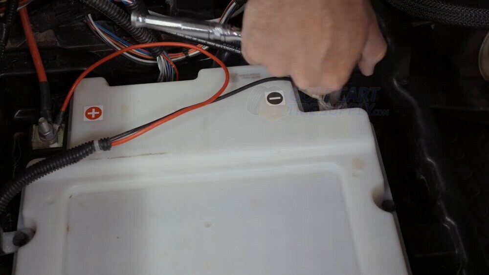 Disconnecting the factory battery terminal cables on an EZGO RXV Loosening and grouping the factory battery terminal cables on a Gen 2 EZGO RXV
