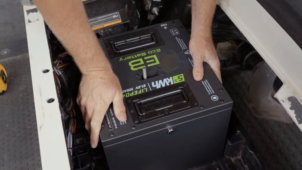 ECO Battery lithium pack lowered over the center rod in the EZGO RXV tray ECO Battery 48V Thru Hole lithium pack being lowered over the center rod in a Gen 2 EZGO RXV tray